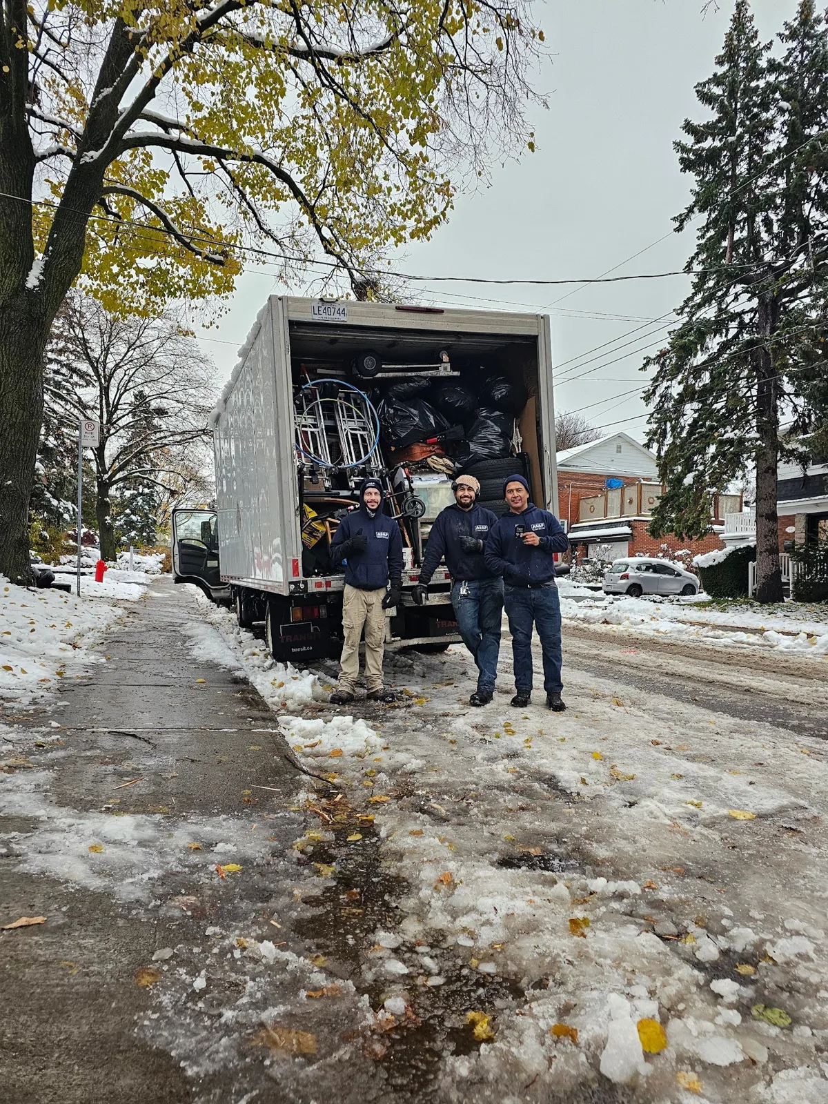 The ASAP Junk Removal crew with a full truck in snowy Montreal