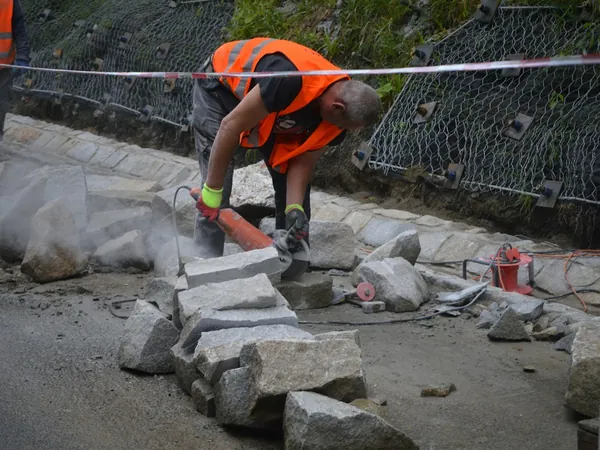 Worker cutting paving stones