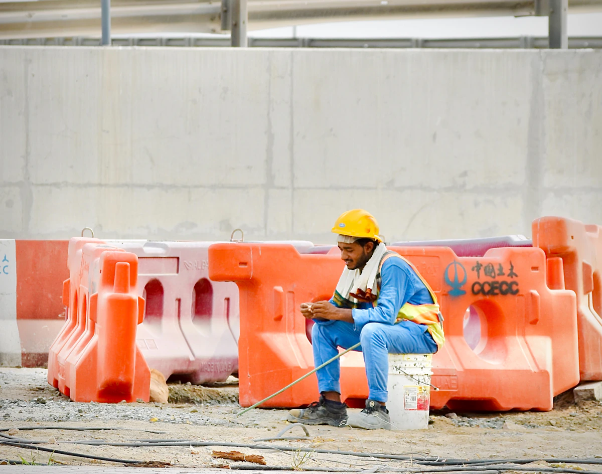 A construction worker checking his phone on site
