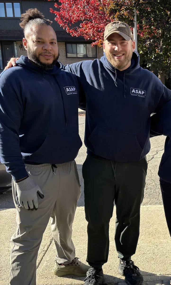 Riley and an ASAP Junk Removal crew member in ASAP hoodies